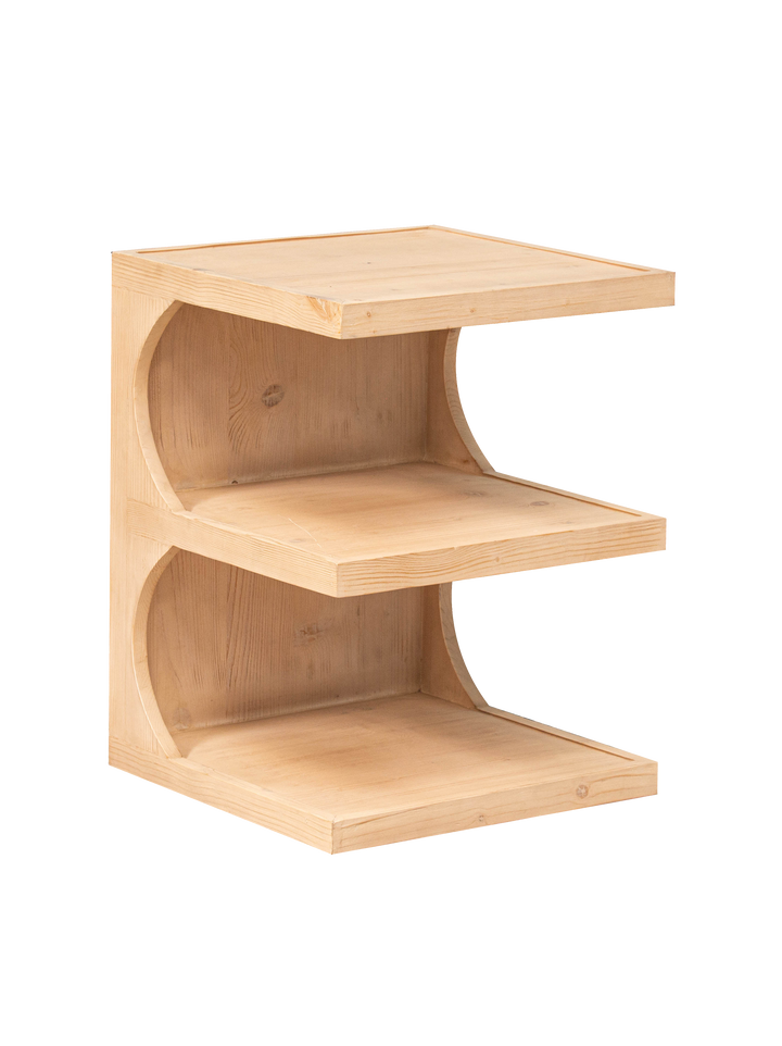 A beige pine wood side table with two shelves, designed to resemble a simple bookcase.